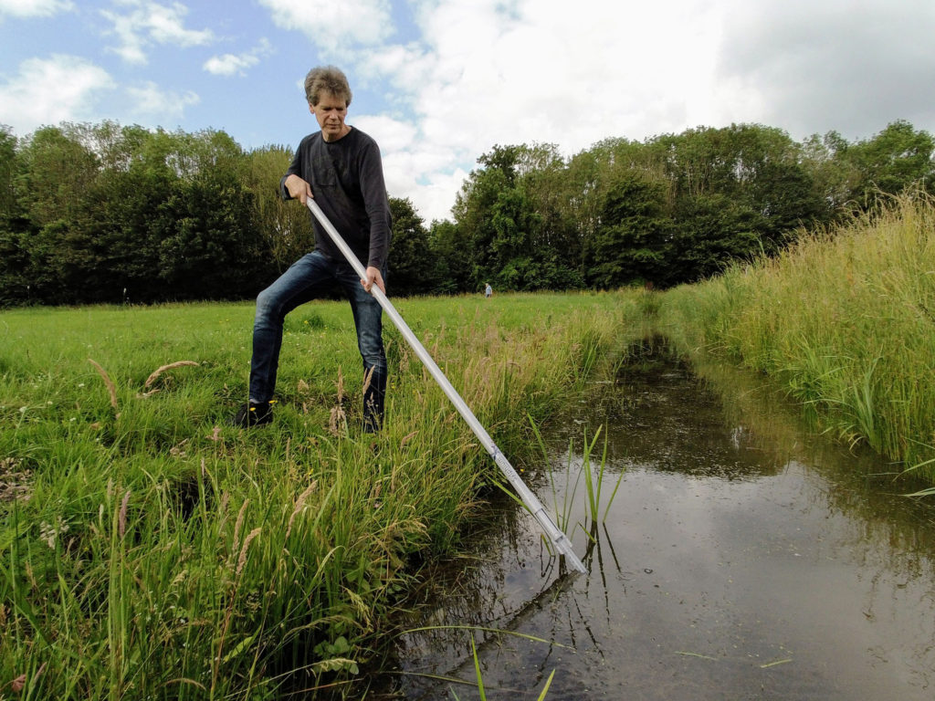 Sampling rod in use among vegetation